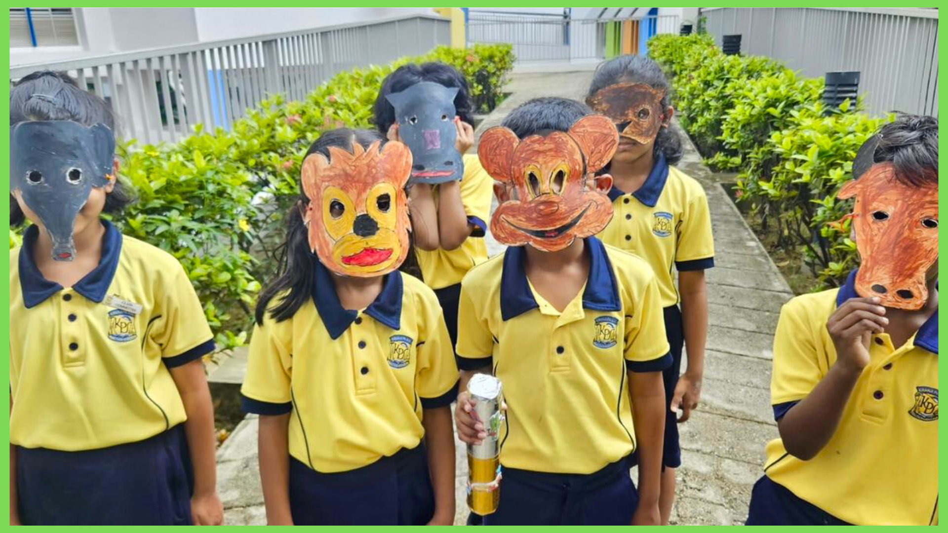 Children in yellow uniforms painting animal masks and posing outdoors wearing colorful handmade animal face masks.